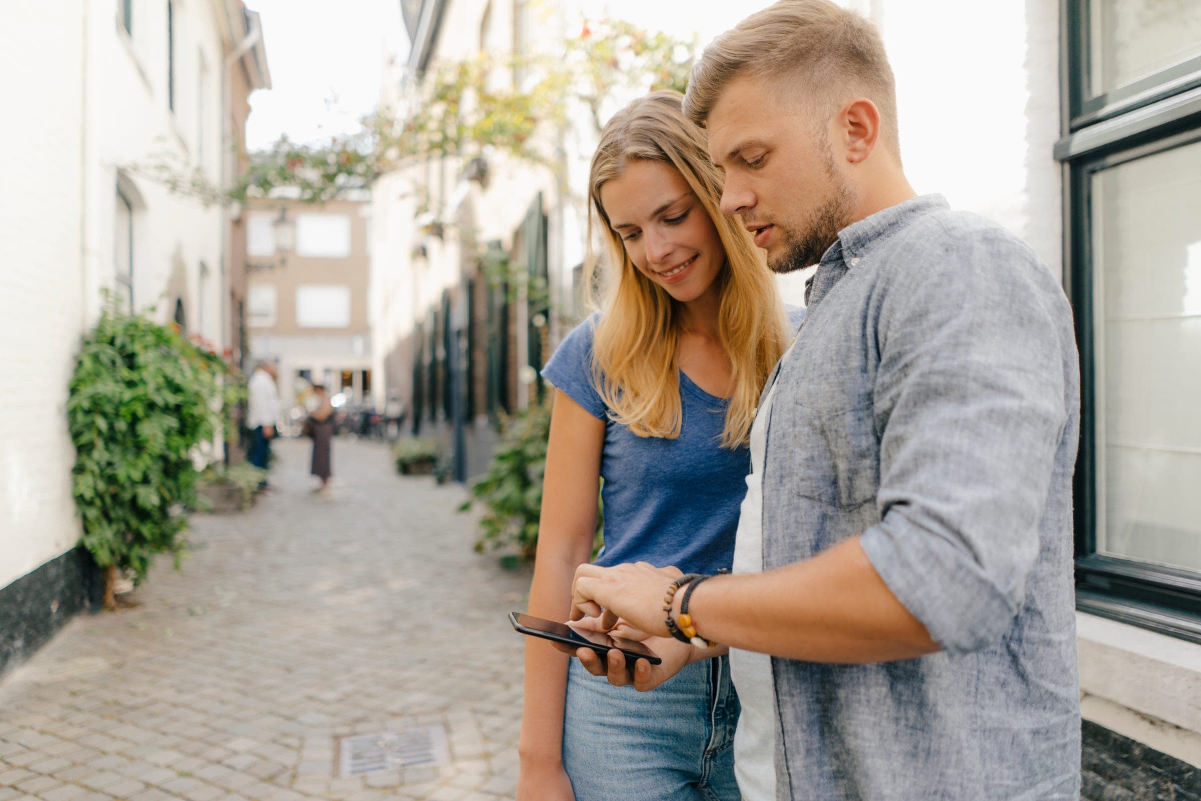 A guest walking a route with their phone in hand, mid-scene.